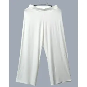 Off-white soft-drape wide-leg pants in viscose knit, styled with nude strappy heels – Lillithe