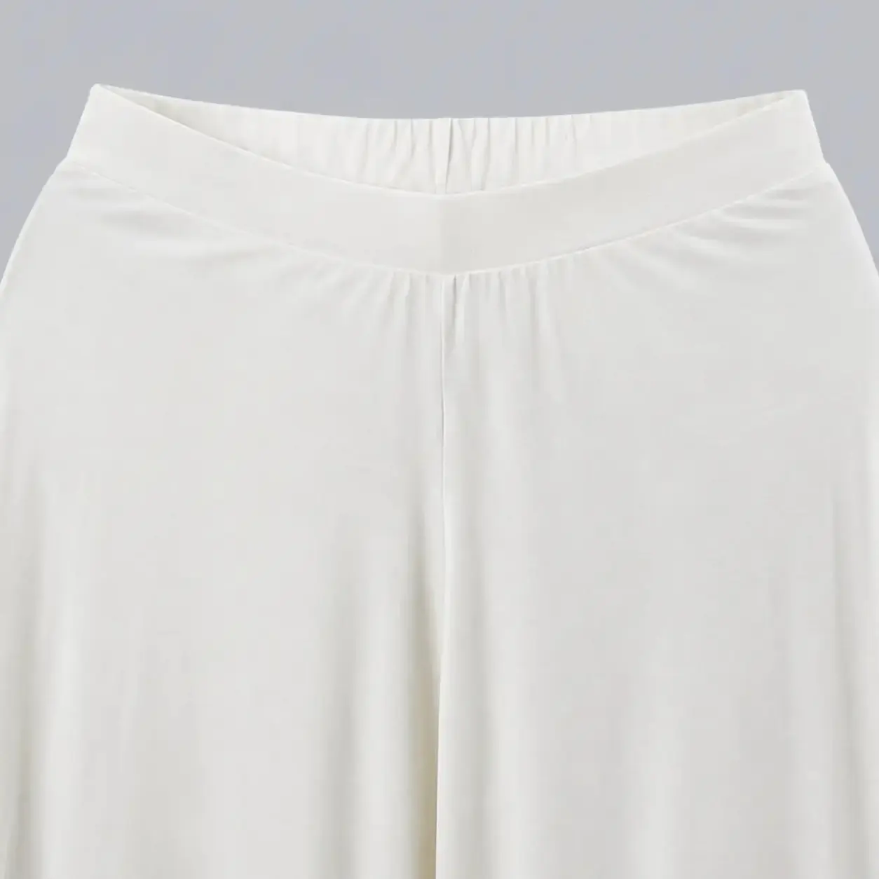 Off-white soft-drape wide-leg pants in viscose knit, styled with nude strappy heels – Lillithe