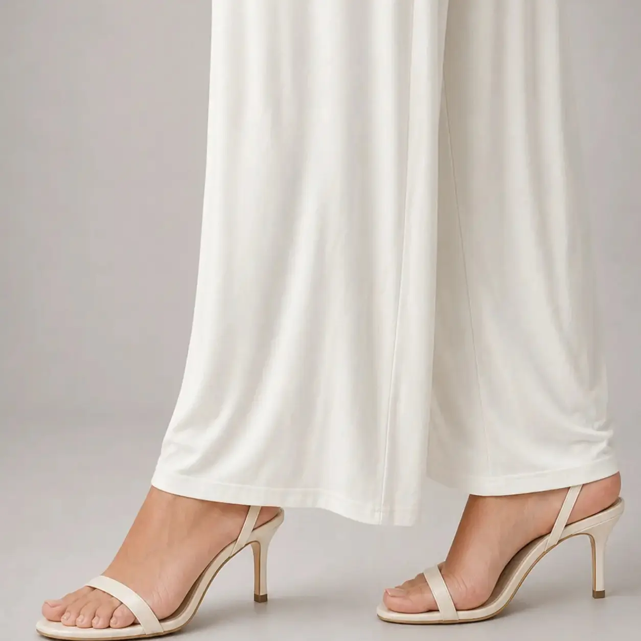 Off-white soft-drape wide-leg pants in viscose knit, styled with nude strappy heels – Lillithe