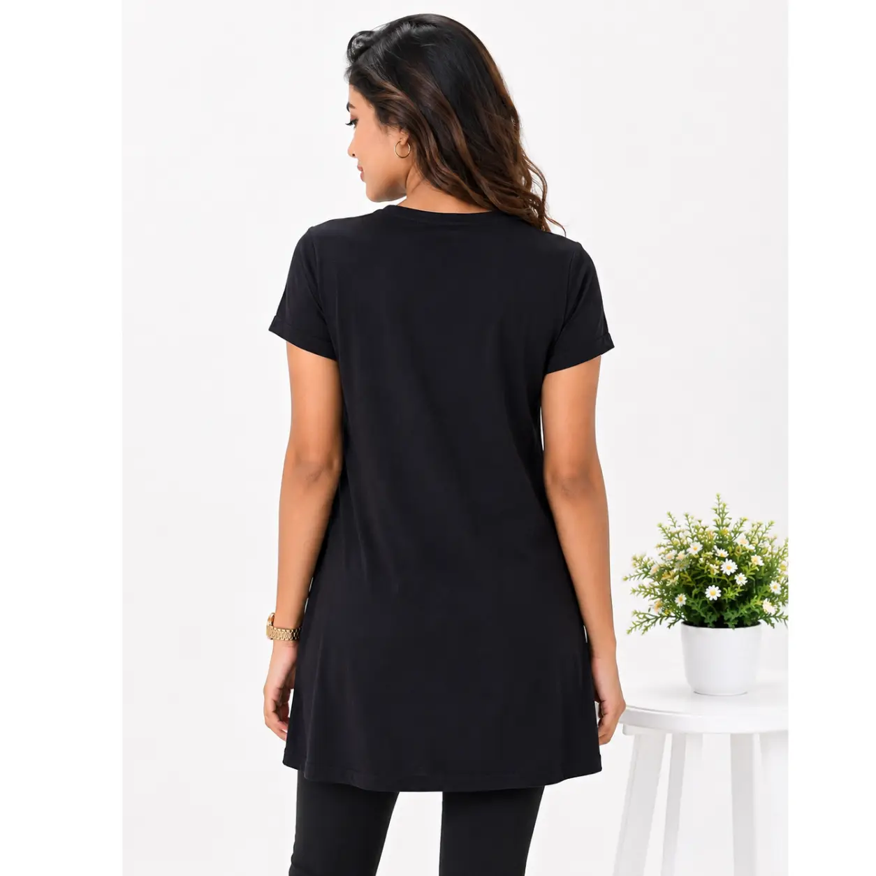 Model wearing Lillithe Essentials black long T-shirt with daisy floral print, paired with black leggings